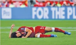  ??  ?? KAI PFAFFENBAC­H/ REUTERS Liverpool’s Mohamed Salah sustains a shoulder injury during the Champions League final defeat against Real Madrid in Kiev’s NSC Olympic Stadium in Ukraine on May 26, 2018.