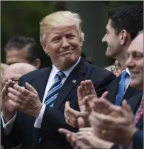  ?? Washington Post photo by Jabin Botsford ?? President Donald Trump looks to House Speaker Paul Ryan, RWis., after the House pushed through a health-care bill. The president, Ryan and others made remarks praising their efforts to, at the time, upend the 2010 Affordable Care Act.