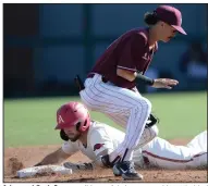  ?? (NWA Democrat-Gazette/Andy Shupe) ?? Arkansas’ Zack Gregory slides safely into second base behind UALR’s Jorden Hussein during Wednesday’s game in Fayettevil­le.