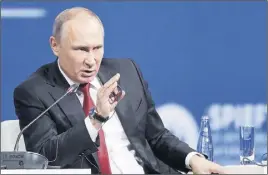  ?? AP PHoto ?? Russian President Vladimir Putin answers a question at the St. Petersburg Internatio­nal Economic Forum in St. Petersburg, Russia.