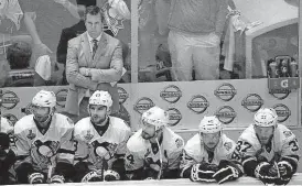  ??  ?? Pittsburgh Penguins head coach Mike Sullivan watches along with his players during the final minutes of the third period in Game 4 of the Stanley Cup Final against the Nashville Predators on Monday in Nashville, Tenn. The Predators won 4-1 to tie the...