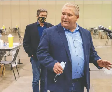  ?? FRANK GUNN/ THE CANADIAN PRESS ?? Ontario Premier Doug Ford speaks while Toronto Mayor John Tory listens. Tory is competing with Ford for the title of most cautious politician, says Randall Denley.