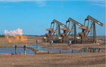  ?? Rex Features ?? Natural gas is flared as oil is pumped in the Bakken shale formation in Watford City, North Dakota, US. The gas is burned because no pipelines have been built to transport it to market.