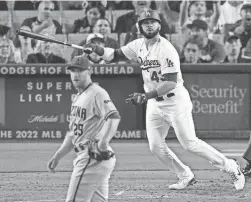  ?? AP ?? The Dodgers’ Edwin Rios watches his three-run homer take flight as D-Backs pitcher Merrill Kelly watches in Game 2 of a doublehead­er on Tuesday.