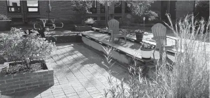  ?? JONATHON GRUENKE/STAFF ?? Flowers, plants and chairs fill a courtyard garden at Palmer Elementary School in Newport News. Bus drivers Lisa Bares and Lou Mahone created the garden while students remain home during remote learning.