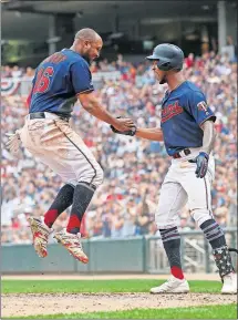  ?? [JIM MONE/THE ASSOCIATED PRESS] ?? Minnesota’s Jonathan Schoop, left, celebrates with Byron Buxton after scoring during Saturday’s game against Texas.