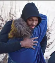  ?? PETE BANNAN — MEDIANEWS GROUP ?? Villanova University and Lower Merion graduate Darryl Reynolds is embraced outside Lower Merion’s Bryant Gymnasium where fans turned out to honor its namesake.