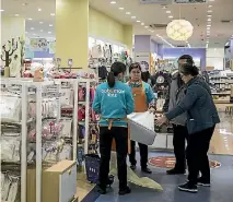  ?? PHOTO: BLOOMBERG ?? Staff show a mattress to customers at a Shanghai Aiyingshi Co Babemax store in Shanghai, China. Mother-baby retail chains such as Babemax emerged in China about a decade ago, mostly near hospitals with big maternity wards, and now account for half of...