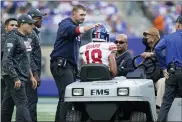  ?? FRANK FRANKLIN II — THE ASSOCIATED PRESS ?? New York Giants head coach Joe Judge, center left, checks on C.J. Board as he is carted off the field during the first half of an NFL football game against the Los Angeles Rams, Sunday, Oct. 17, 2021, in East Rutherford, N.J.