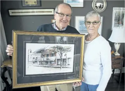  ?? JULIE JOCSAK/STANDARD STAFF ?? Frank and Gail Coy show a framed picture of their old store, Coy Bros., on James Street. The store closed in 1991 after 140 years of business.