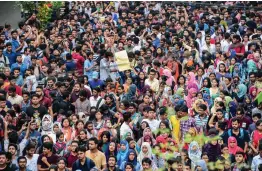  ?? — AFP ?? Bangladesh­i students march along a street during a student protest in Dhaka on Sunday, following the deaths of two college students in a road accident.