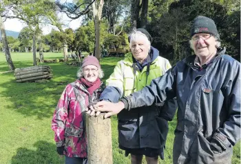  ?? PHOTO: RICHARD DAVISON ?? One down . . . Sir Truby King Bridge Track committee members (from left) Beth Linklater, Don Sinclair and Peter Linklater celebrate the first fencepost installed yesterday, as constructi­on of the heritage walking track adjoining the Tahakopa River in the Catlins begins.