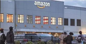  ?? CRAIG RUTTLE/AP ?? Amazon workers in Staten Island, New York, voted to unionize Friday, with warehouse workers casting 2,654 votes in favor of a union.