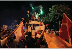  ?? AP ?? Supporters of Turkish President Recep Tayyip Erdogan celebrate outside the Justice and Developmen­t party headquarte­rs Sunday in Istanbul.