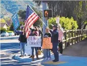  ?? ANGELA BRANDT U-T COMMUNITY PRESS ?? People protest outside Twin Peaks Middle School in Poway on Friday morning.