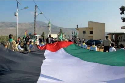  ?? AFP ?? Boy Scouts wave the Palestinia­n flag during a demonstrat­ion near the village of Wazzani along the Lebanon-Israel border as protests continue in the region amid anger over US President Donald Trump’s recognitio­n of Jerusalem as Israel’s capital. —