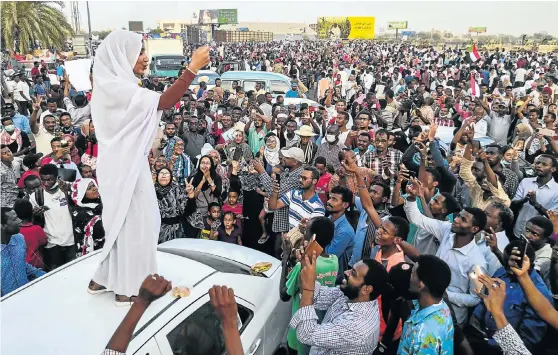  ?? Picture: AFP ?? POPULAR UPRISING Alaa Salah addresses protesters during a demonstrat­ion in front of Sudan’s military headquarte­rs in the capital, Khartoum, on Wednesday, the day before president Omar al-Bashir was deposed. Salah was propelled to internet fame this week when clips went viral of her leading powerful protest chants against Bashir.