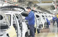  ?? — Reuters photo ?? Employees work on Baojun RS-5 cars at a final assembly plant operated by General Motors Co and its local joint-venture partners in Liuzhou, Guangxi Zhuang Autonomous Region, China.