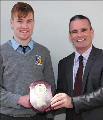  ??  ?? Stephen Murphy receiving the Jim Lyons Award from Principal Denis O’Donovan at St Patrick’s in May of this year.