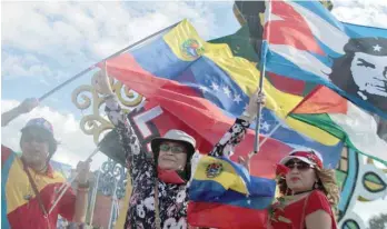  ??  ?? Sandinista supporters march in homage to Venezuelan late president Hugo Chavez in Managua Nicaragua on the sixth anniversar­y of his death. — AFP