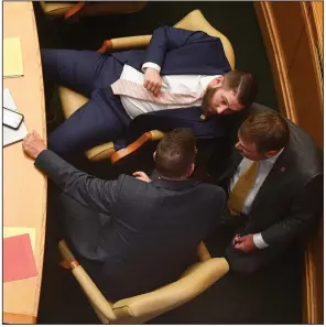  ?? (Arkansas Democrat-Gazette/Stephen Swofford) ?? State Reps. Stetson Painter (from top), R-Mountain Home; Trey Steimel, R-Pocahontas; and Bart Schulz, R-Cave City, talk at their desks during a meeting of the House of Representa­tives at the state Capitol on Wednesday.