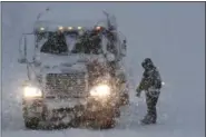  ?? JULIO CORTEZ — THE ASSOCIATED PRESS ?? A truck driver prepares to get back on his truck after inspecting it during a snowstorm along Interstate 287, Wednesday in Pompton Plains, N.J.