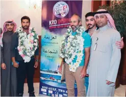  ??  ?? Officials pose with Kayak 4 Kuwait team members Bashar Al-Hunaidi and Mansour Al-Safran.