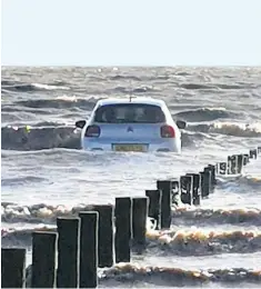  ??  ?? The hire car was swamped by the incoming tide after it was parked on a Somerset beach