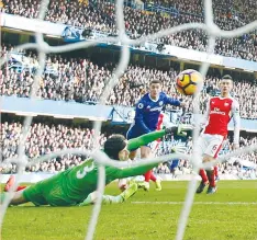  ?? (Reuters) ?? EDEN HAZARD (center) scores Chelsea’s second goal in its 3-1 drubbing of Arsenal yesterday in London.