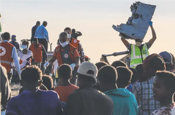  ?? Picture: AFP ?? GRIM TASK: Medical and emergency personnel at the scene of the Ethiopian Airlines crash, about 60km southeast of Addis Ababa.