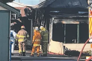  ?? ?? Fire crews at the scene of a house which was destroyed by fire at Ridgley on Tuesday.