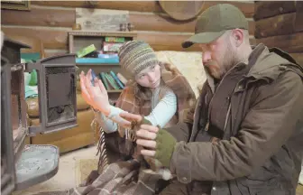  ??  ?? SURVIVAL: Ben Foster, right, plays a veteran who lives in a nature preserve with his daughter (Thomasin Harcourt McKenzie, left) in ‘Leave No Trace.’