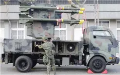  ??  ?? TAINAN: A Taiwan soldier operates home-made Tien Chien surface-to-air missiles during an annual drill. — AFP