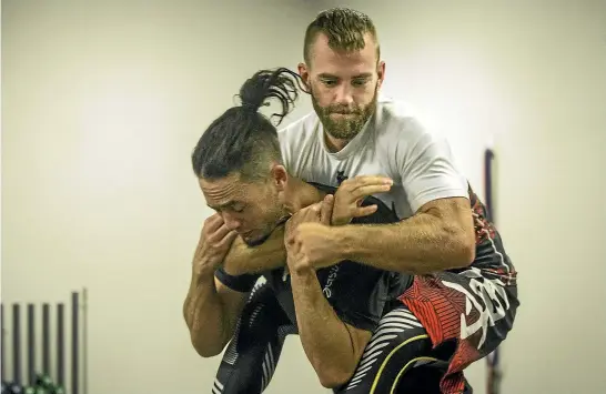  ?? VIRGINIA WOOLF/STUFF ?? Jamie Sumner puts a rear naked choke on his jiu-jitsu instructor Corey Boland. Sumner is vision-impaired but has won a national title in the sport.