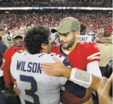  ?? Carlos Avila Gonzalez / The Chronicle 2019 ?? QB Jimmy Garoppolo, congratula­ting Russell Wilson after the 49ers lost to the Seahawks in 2019, has suffered three significan­t injuries in his 32start career. Wilson has missed no time in 138 starts.