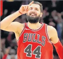  ?? AP PHOTO ?? Chicago Bulls’ Nikola Mirotic celebrates as his team pulls away from the Philadelph­ia 76ers during an NBA game Monday in Chicago.