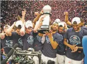  ?? FRANK FRANKLIN II/THE ASSOCIATED PRESS ?? Villanova players hold the tournament trophy after the Big East championsh­ip against Providence on Saturday in New York. Villanova won 76-66 in overtime.