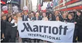  ?? CHARLES SYKES, AP FOR MARRIOTT ?? Bill Marriott and Arne Sorenson join with the Marriott team in Times Square to celebrate the company’s acquisitio­n of Starwood on Friday.