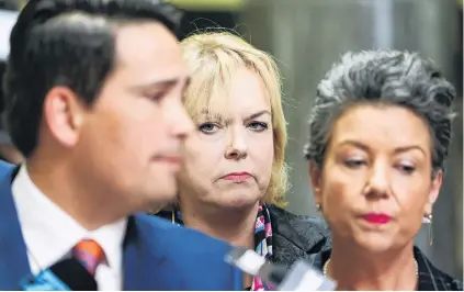  ?? PHOTO: GETTY IMAGES ?? Grimfaced . . . National Party leader Simon Bridges speaks to media yesterday supported by MP Judith Collins and deputy leader Paula Bennett.