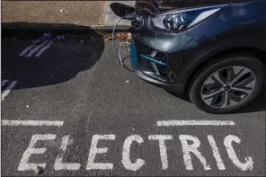  ?? (Bloomberg [WPNS]/Chris Ratcliffe) ?? A curbside electric vehicle charging point is clearly marked in London.
