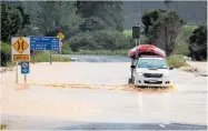  ?? Photo / Mike Scott ?? Flooding on the road to Hahei at Cook’s Beach, Coromandel.