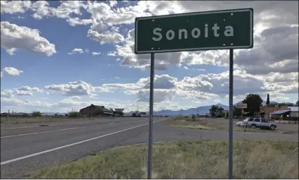  ??  ?? In this photo taken on May 13, a sign for Sonoita stands in the heart of southeaste­rn Arizona where owners of wineries and other small tourism operations worry that the Rosemont Copper Mine proposed to be built in the nearby Santa Rita Mountains could harm their businesses with mining trucks rumbling down scenic state highway 83 that runs past the range.