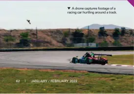  ?? ?? A drone captures footage of a racing car hurtling around a track.