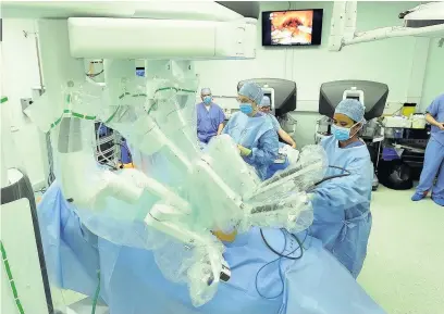  ??  ?? ■ Surgeons and staff at the University Hospital of Wales operate on a prostate cancer patient using the latest Da Vinci robotic surgery equipment 110516ROBO­TIC_10 RICHARD WILLIAMS