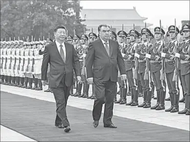  ??  ?? Chinese President Xi Jinping (L) views an honour guard with visiting President of Tajikistan Emomali Rahmon during a welcome ceremony before their talks in Beijing, capital of China. Rahmon is paying a state visit to China. During his stay in China, he...