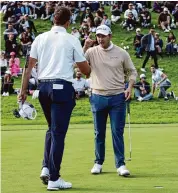  ?? Harry How/Getty Images ?? Patrick Cantlay, right, shakes hands with Luke List on the 18th green at the Genesis Invitation­al.