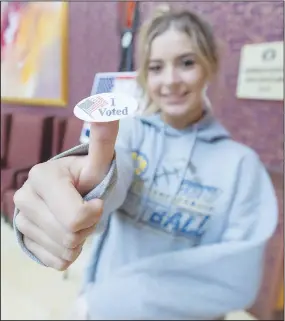  ?? (NWA Democrat-Gazette/J.T. Wampler) ?? Grace Wixson of Rogers shows off her sticker Tuesday after voting for the first time at the Rogers Convention Center. Residents of Benton County voted on school board positions and a school tax. Visit nwaonline.com/211103Dail­y/ for more photos.