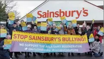  ??  ?? ‘WE’VE DONE IT’:
Protesters outside Sainsbury’s in South Ruislip have won their battle against the store giant