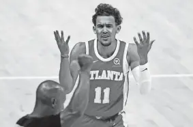  ?? BRYNN ANDERSON/AP ?? Hawks guard Trae Young disputes a foul called by a referee during Game 3 of the Eastern finals against the Bucks on June 27 in Atlanta.