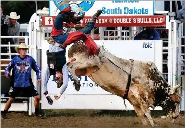  ?? ASSOCIATED PRESS ?? In this Aug. 18, 2018, file photo, Jordan Allen of Buffalo, Mo., is thrown from this bull during competitio­n at the Extreme Bull Riding Tour stop in Yankton, S.D. Profession­al Bull Riders has announced a new series of competitio­n that will culminate in South Dakota on July 10-12 with live crowds.